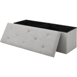 Gray tufted storage bench with a black top on a white background
