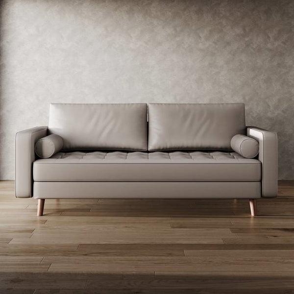 Beige sofa against a textured wall on a wooden floor