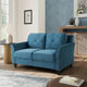Blue sofa in a living room setting with decor elements.