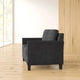 Black armchair in a room with wooden floor and light-colored walls
