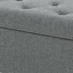 Gray upholstered storage ottoman with tufted design