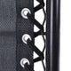 Close-up of black laces being tied on a black shoe with white eyelets.