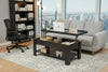Black coffee table with lift-top design, laptop, and decorative items on the table with New York City in the background