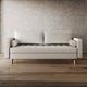 Beige sofa against a textured wall on a wooden floor