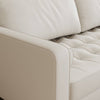 Close-up of a beige leather sofa with quilted details