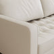 Close-up of a beige leather sofa with quilted details