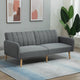 Gray sofa in a living room with abstract art and a plant.