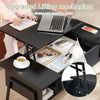 Black adjustable desk with laptop on top, showing lifting mechanism, and a cup of coffee.