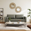 Modern living room with a gray sofa, wooden coffee table, and decorative mirrors on the wall.