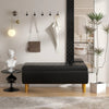 Modern interior with a black bench, wall hooks, and decorative items.