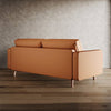 Brown sofa in a room with wooden floor and gray wall